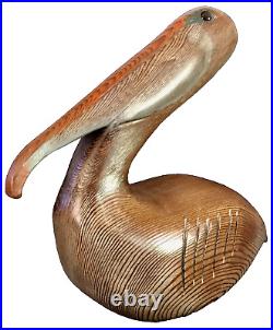 Vintage Hand Carved Solid Wood Pelican Sculpture withglass eyes. Signed by artist